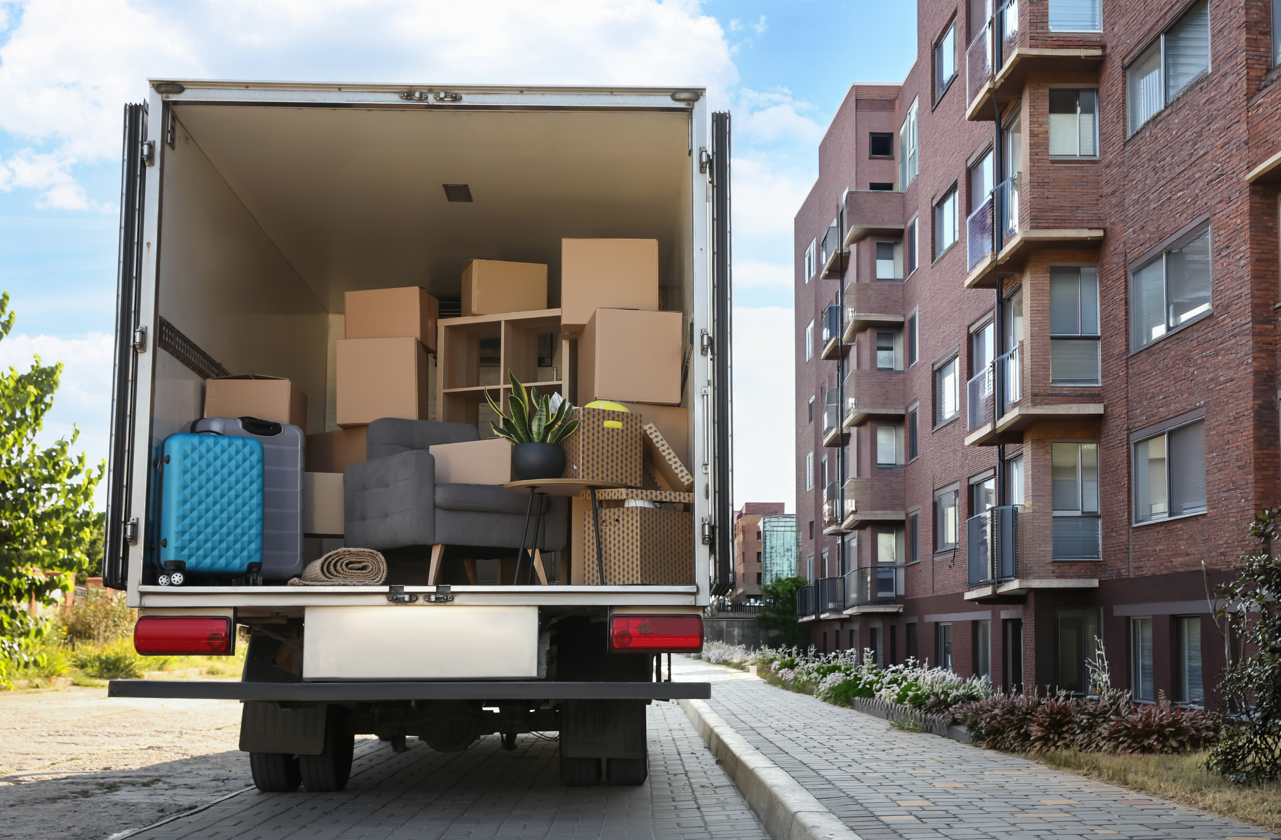 Boston September 1 Move-In Day with moving trucks and renters outside Boston apartments.